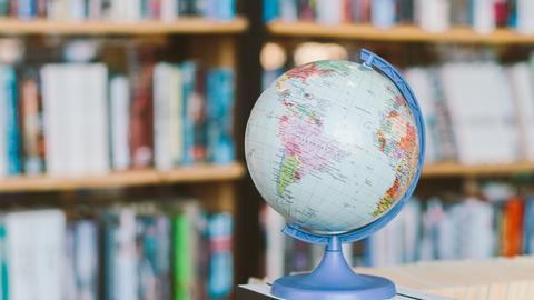 A globe in front of a bookcase